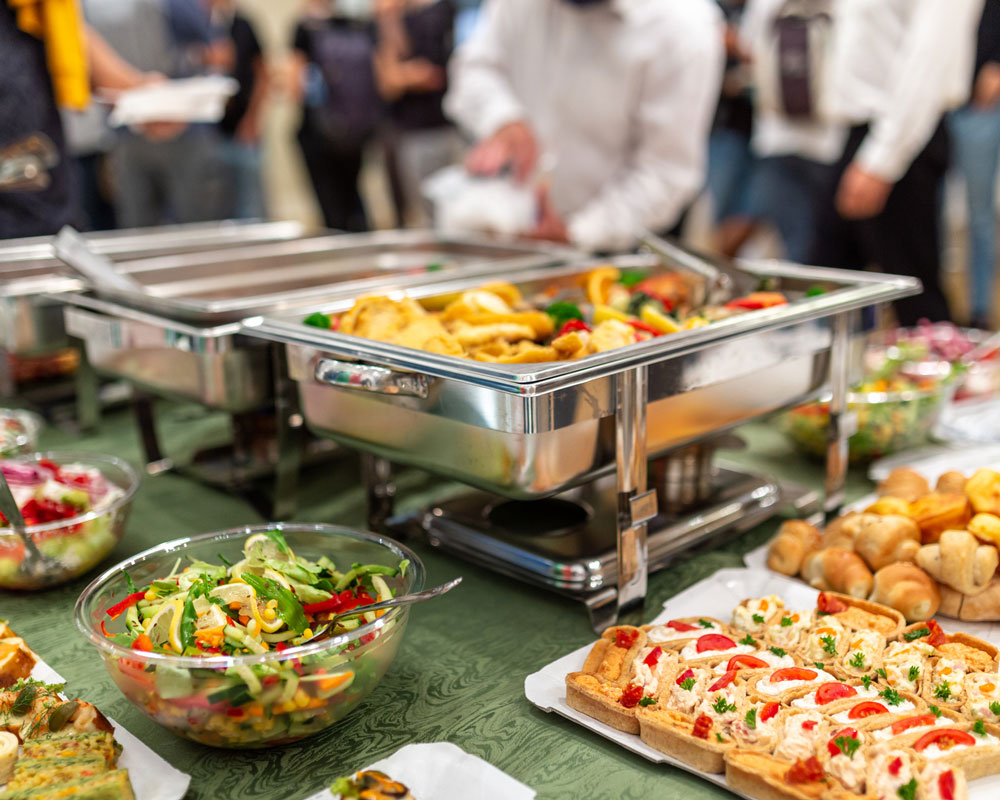 Catering services showing foods within stainless steel hot plates.